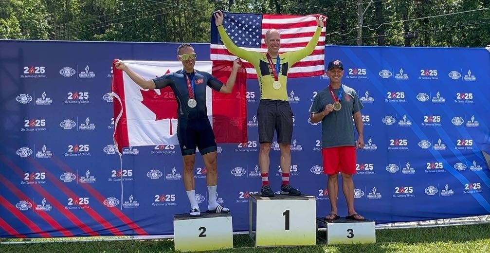 Officer Sean Martin wearing his gold medal on champion podium